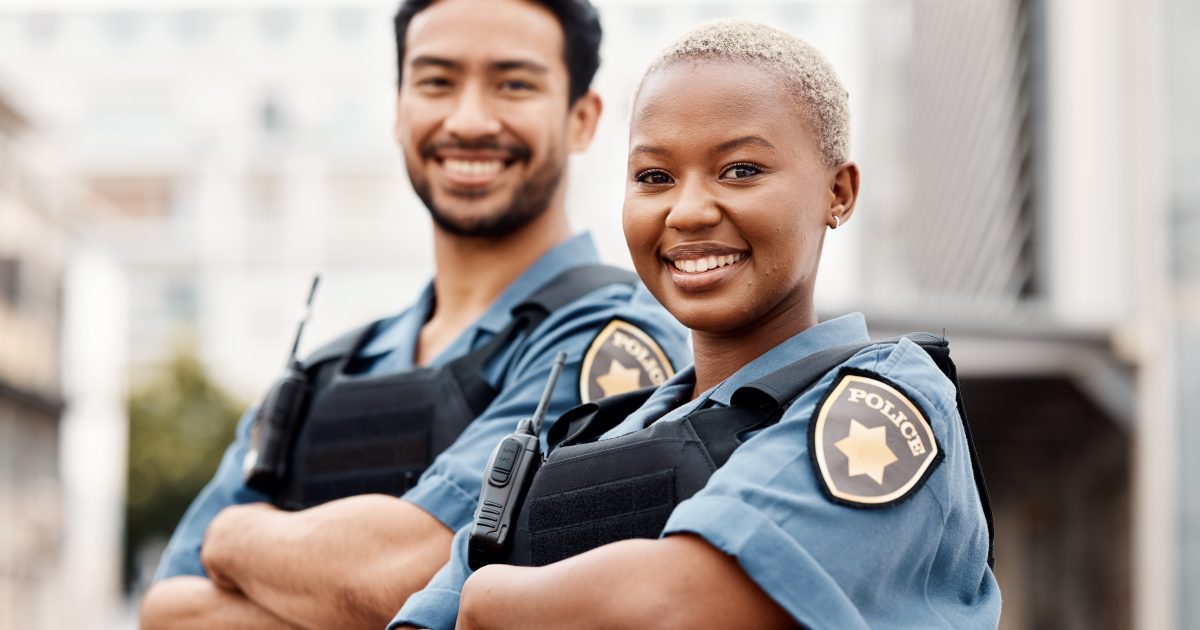 Happy police, team and arms crossed in confidence for city protection, law enforcement or crime.